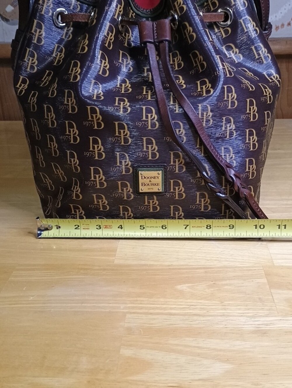 Dooney & Bourke Sutton Brown Logo Drawstring Bucket Bag with Red Interior - Picture 2 of 12